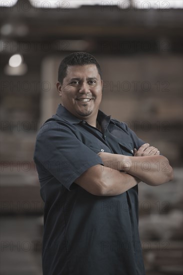 Hispanic worker standing in warehouse