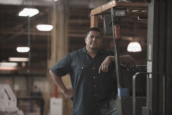 Hispanic worker standing in warehouse