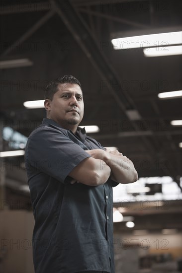 Hispanic worker standing in warehouse