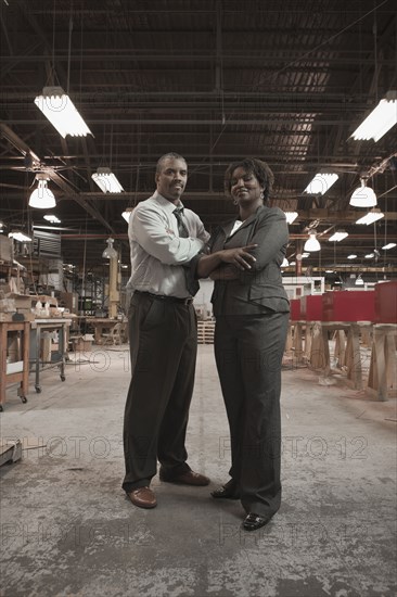 Black business people standing in warehouse