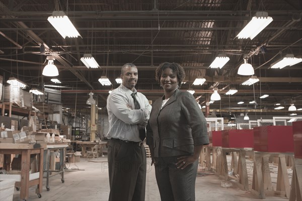 Black business people standing in warehouse