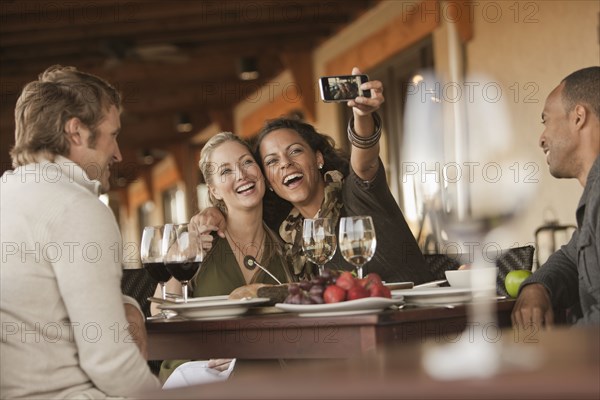 Women taking self-portrait in restaurant