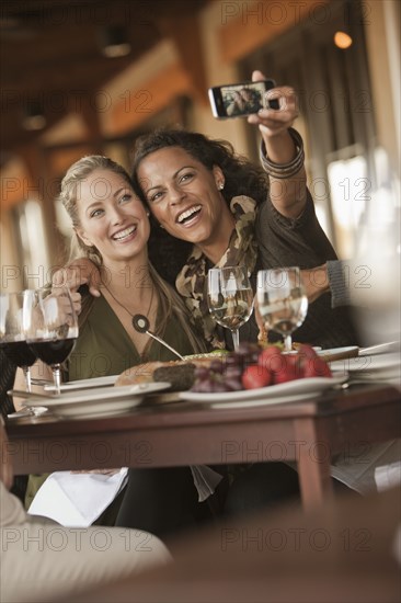 Women taking self-portrait in restaurant