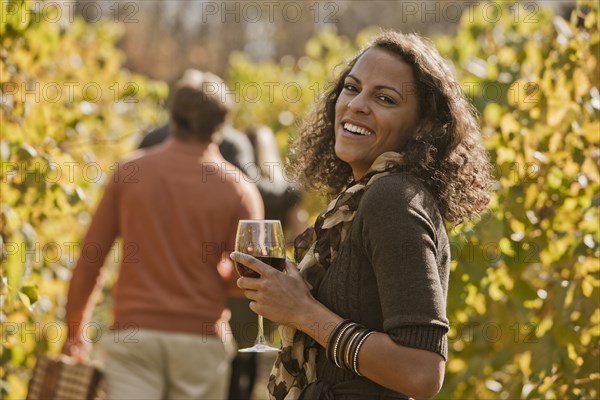 Friends drinking wine in vineyard