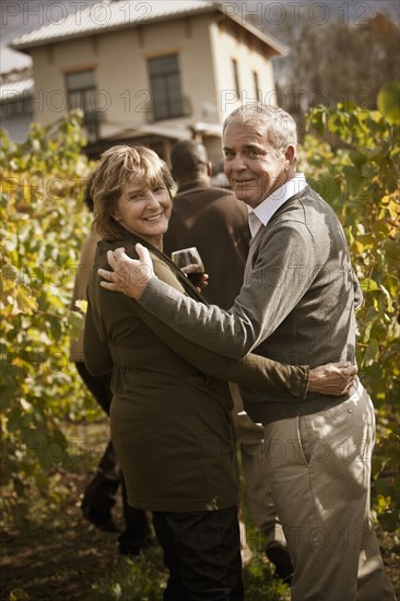 Friends drinking wine in vineyard