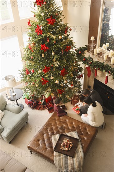 Family opening gifts Christmas morning