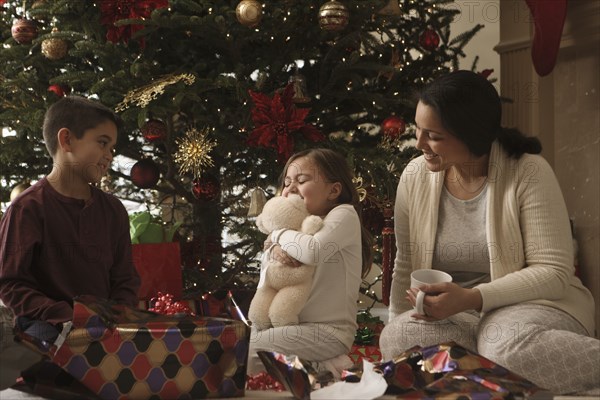 Family opening gifts Christmas morning