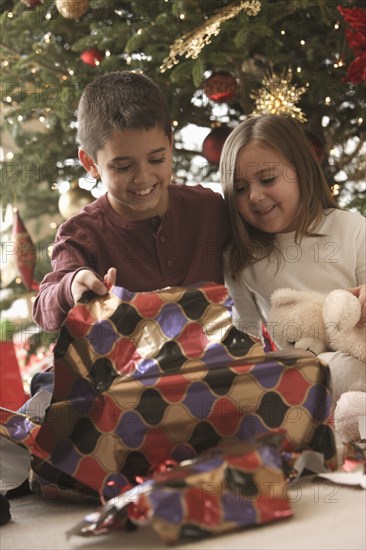 Children opening gifts Christmas morning