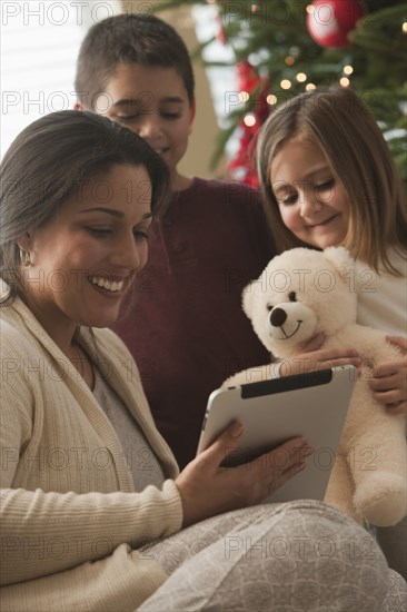 Family looking at digital tablet on Christmas morning