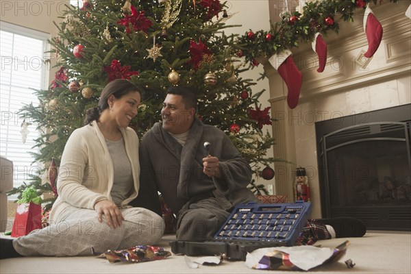 Couple opening gifts on Christmas morning