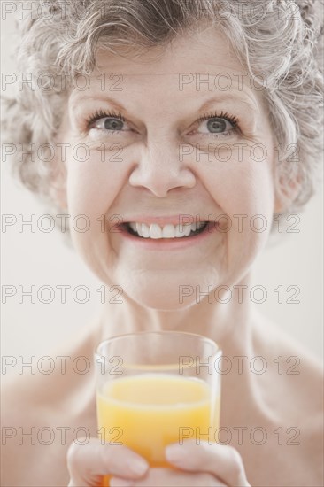 Caucasian woman drinking orange juice