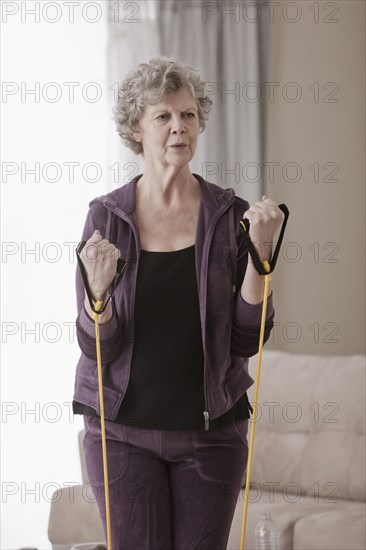 Caucasian woman exercising in living room