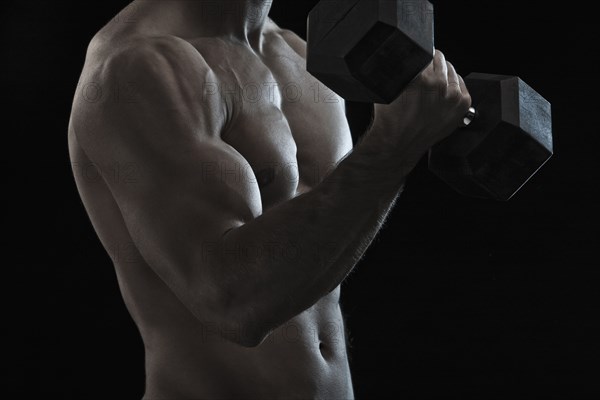 Caucasian man exercising with hand weights