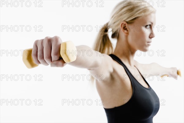 Caucasian woman exercising with hand weights