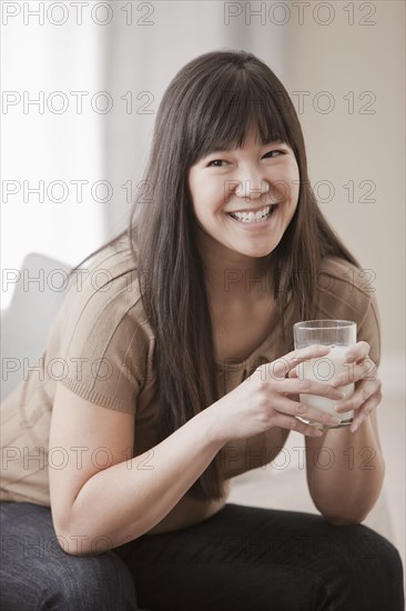 Asian woman drinking milk