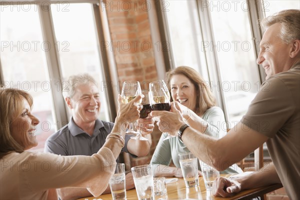 Caucasian friends toasting with wine