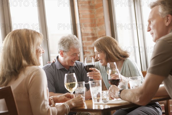 Caucasian friends drinking wine in restaurant