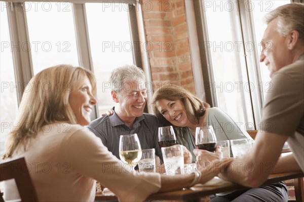 Caucasian friends drinking wine in restaurant