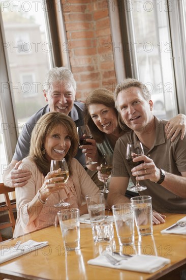 Caucasian friends drinking wine in restaurant