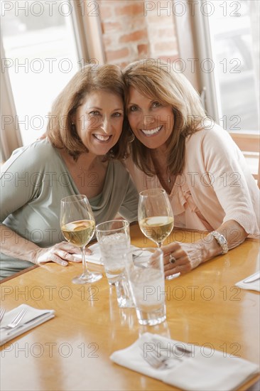 Caucasian friends drinking wine in restaurant