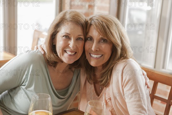 Caucasian friends drinking wine in restaurant