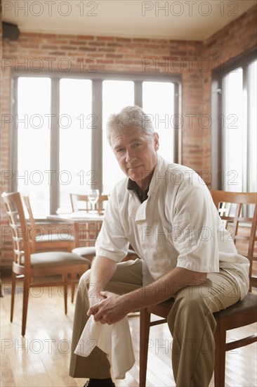 Caucasian chef sitting in restaurant