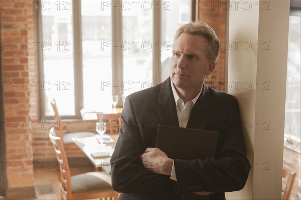 Caucasian owner standing in restaurant