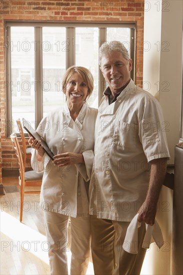 Caucasian chefs standing in restaurant