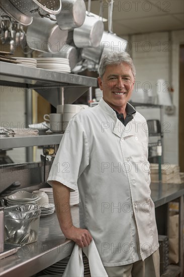 Caucasian chef standing in commercial kitchen