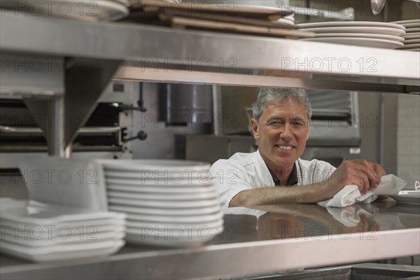 Caucasian chef standing in commercial kitchen