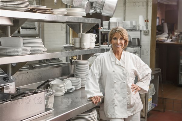 Caucasian chef standing in commercial kitchen