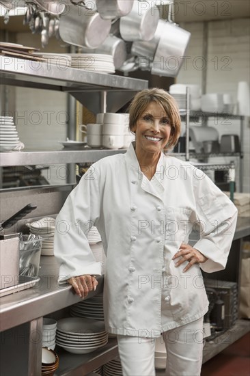 Caucasian chef standing in commercial kitchen