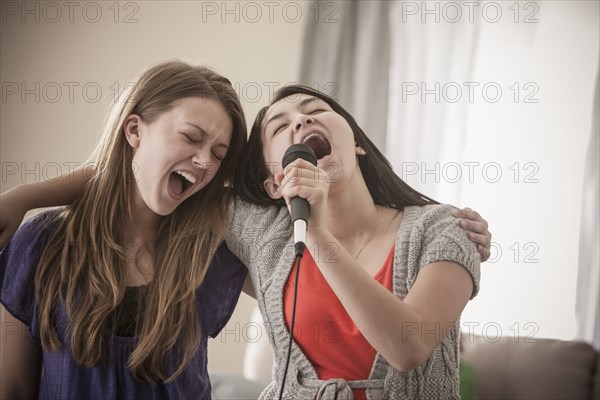 Friends singing karaoke together