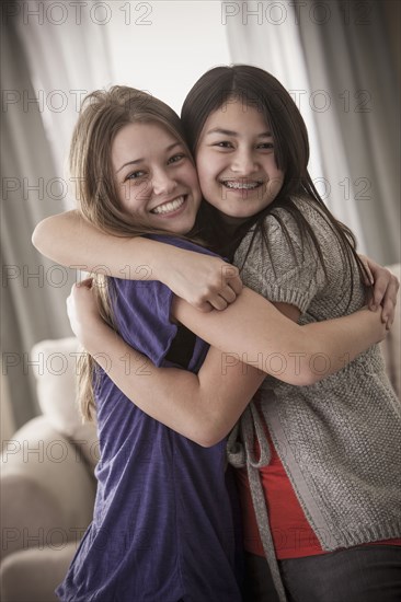 Smiling friends hugging