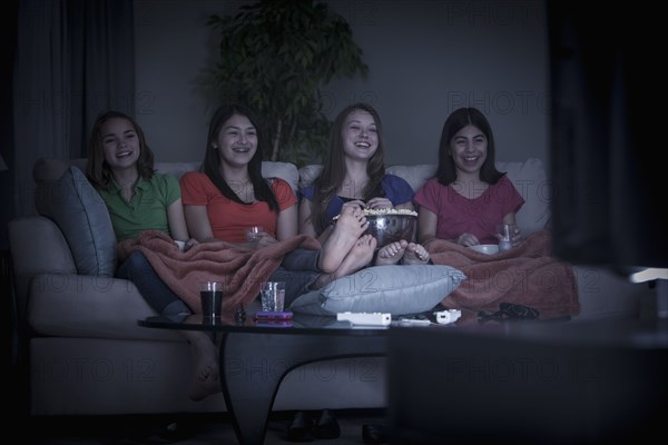 Friends eating popcorn and watching a movie