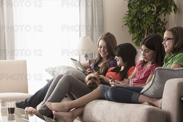 Friends hanging out on sofa together