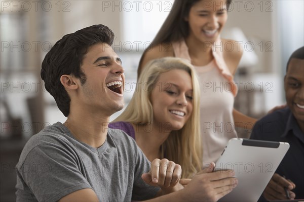 Friends sharing a digital tablet