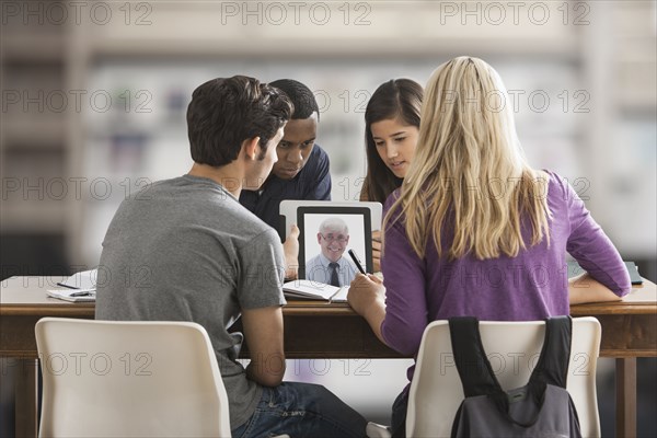 Friends studying together using digital tablet