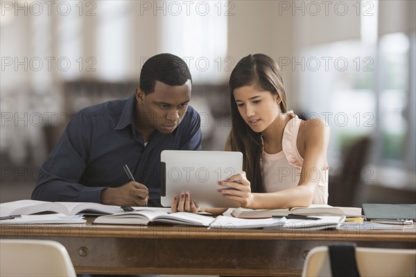 Friends studying with digital tablet
