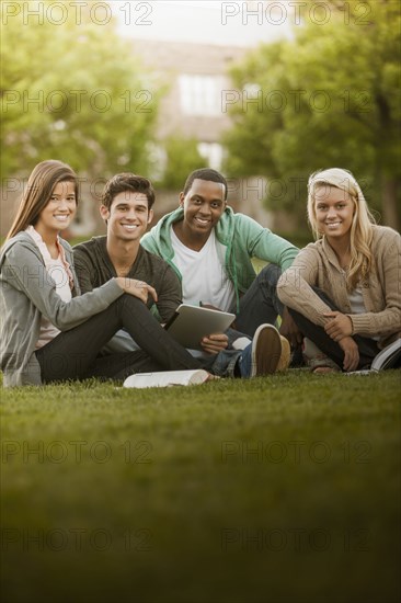 Students sitting together on grass