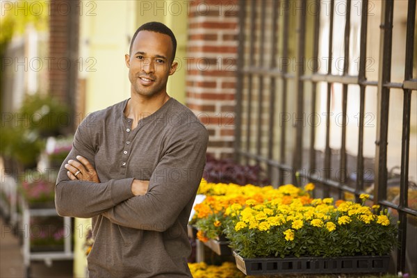 African American man standing near flower shop