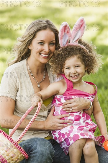 Smiling mother and daughter at Easter