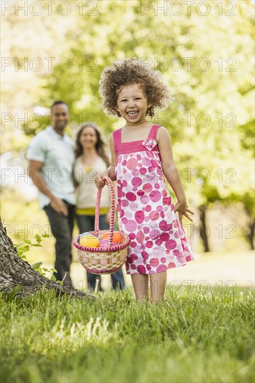 Mixed race girl on Easter egg hunt