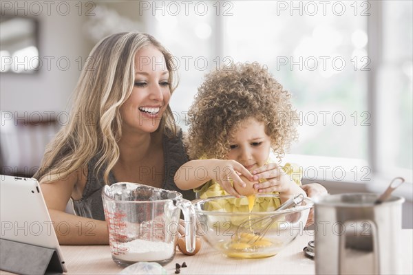 Mother and daughter baking together