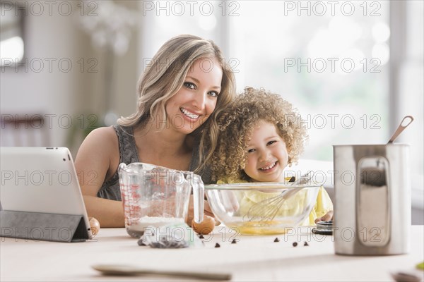 Mother and daughter baking together