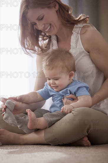 Caucasian mother holding son on lap