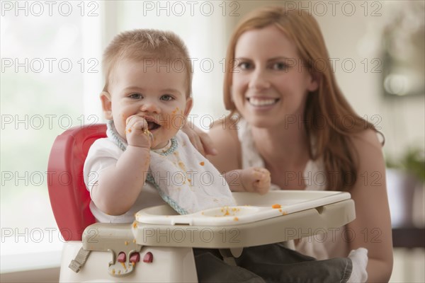 Caucasian mother feeding son