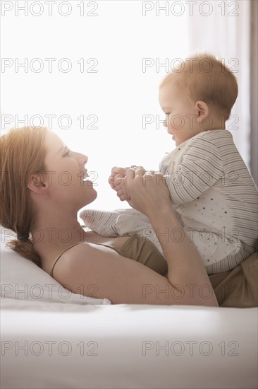 Caucasian mother playing with son