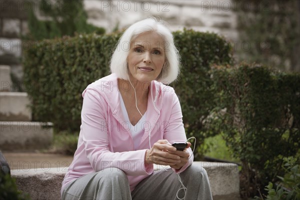 Caucasian woman listening to mp3 player