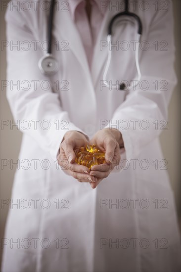 Caucasian doctor holding pills